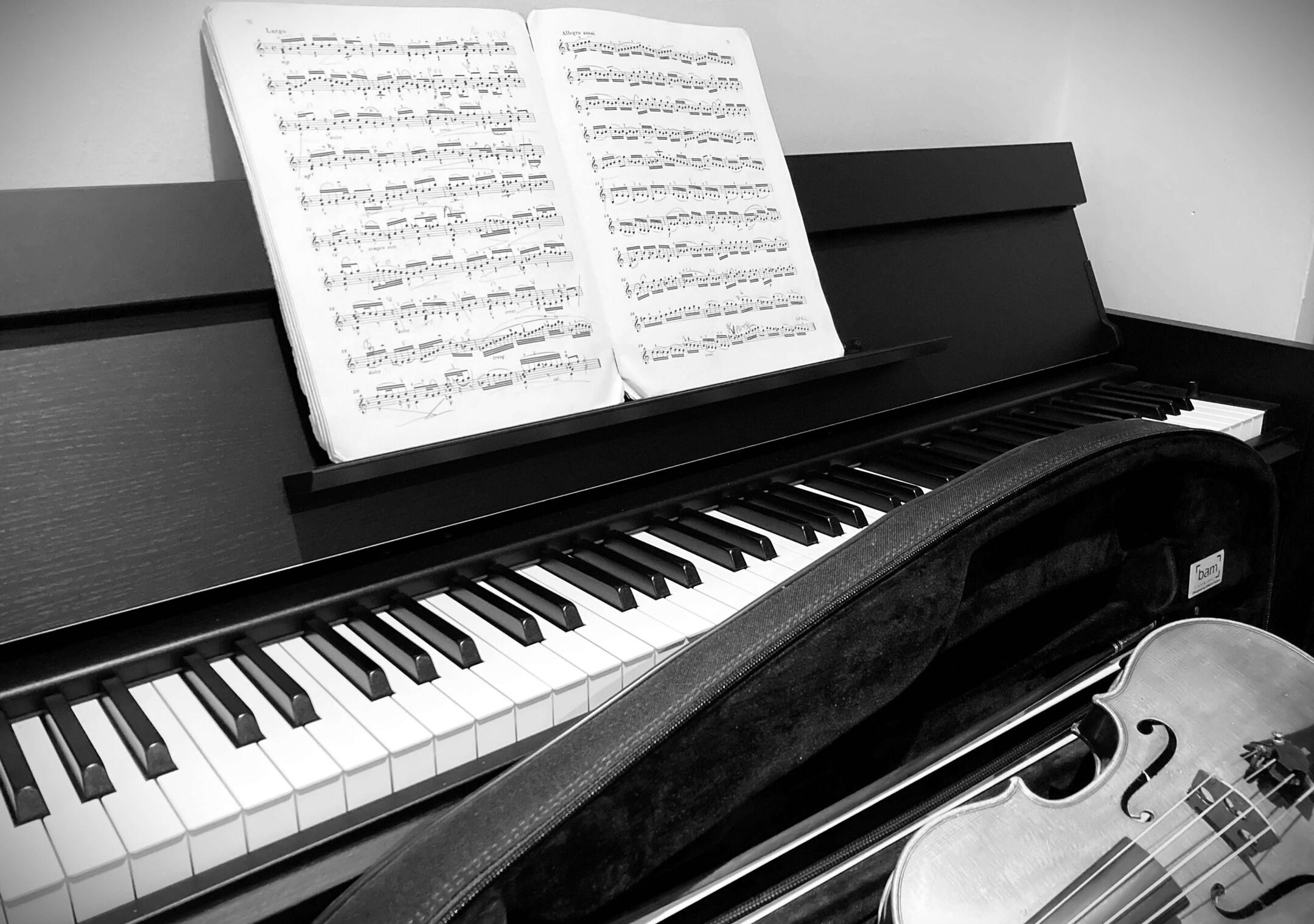 Violin piano Piano and violin with sheet music illustrating music theory concepts.